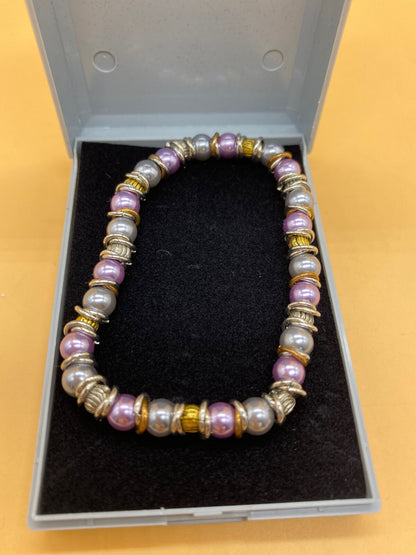 Elasticated Purple and Silver Bead Bracelet with Gold and Silver Metal Rings