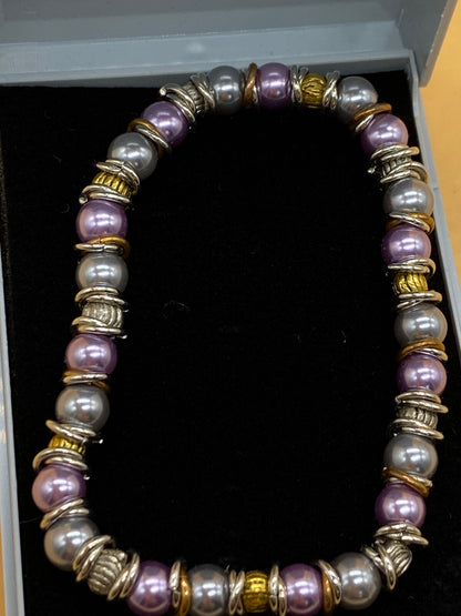 Elasticated Purple and Silver Bead Bracelet with Gold and Silver Metal Rings